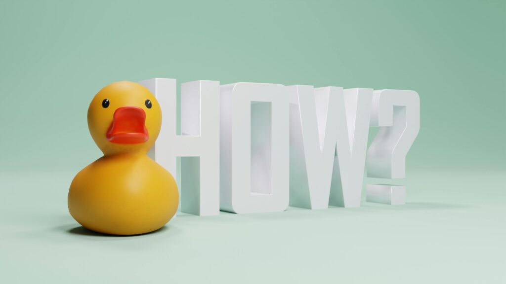 A playful rubber duck next to the word HOW against a green background.